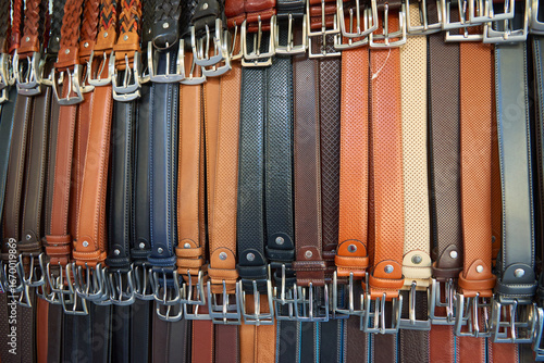 Fototapeta Naklejka Na Ścianę i Meble -  Close-up of men's leather belts made in Italy, for sale at a street market