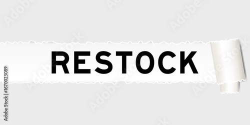 Ripped gray paper background that have word restock under torn part