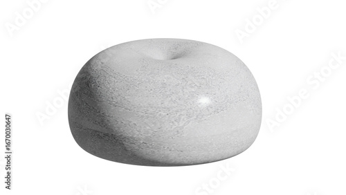 A smooth gray stone with a small indentation on top sitting on a plain white background in a studio shot