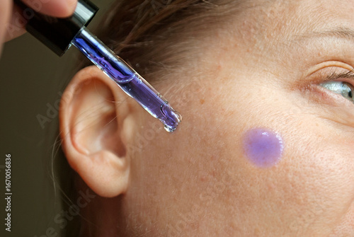 Woman applying Methylene Blue Serum to her face
