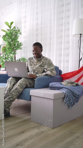 American soldier relaxing at home using laptop