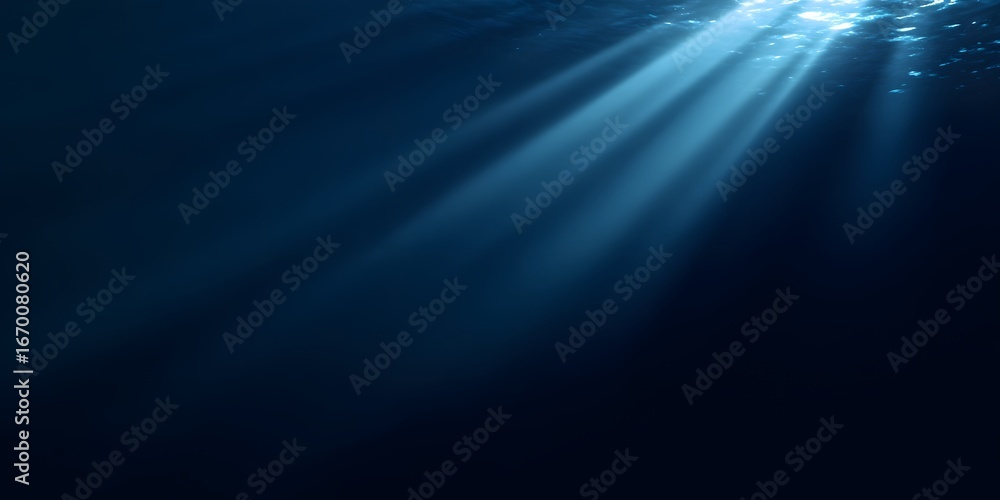 Obraz premium A dark blue background with rays of light shining down, creating an underwater effect. 