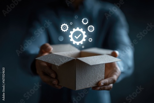 Open box with glowing gears and checkmark, person's hands