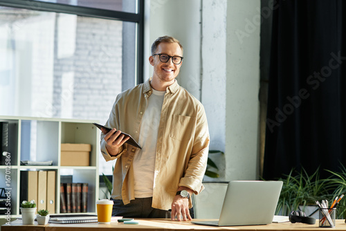 Fototapeta Bright and inspiring moment with a young businessman in a modern office setting