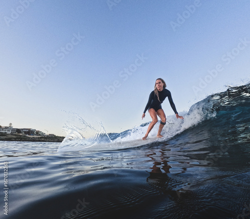 Woman surfing longboard on small clean wave