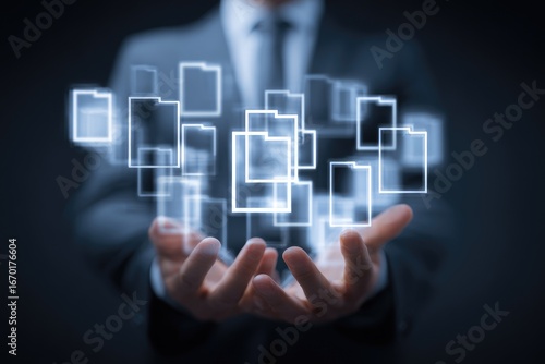 Businessman's hands holding a holographic projection of many folders