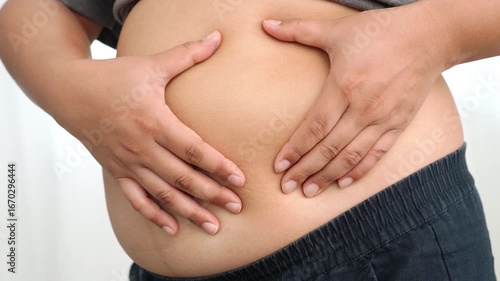 Wallpaper Mural 4K Asian woman use hand to squeeze fat belly big size overweight and obesity. Torontodigital.ca