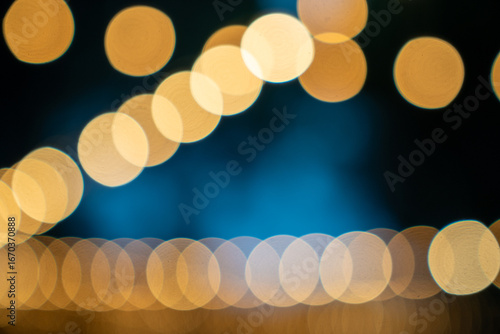 beautiful golden light on a midnight blue background (bokeh) - Christmas lights on a midnight blue background