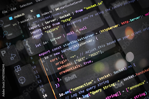 Close-up of colorful TypeScript code for server and socket connection overlayed on a computer keyboard. Perfect for web developers, programmers, tech blogs, coding, and software development content.
