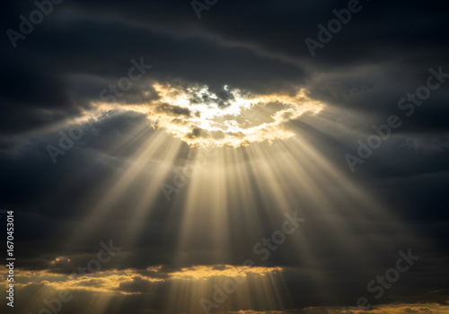 Dramatic sun rays piercing through storm clouds create a scene of hope and divine light for inspirational projects, faith imagery and powerful concepts