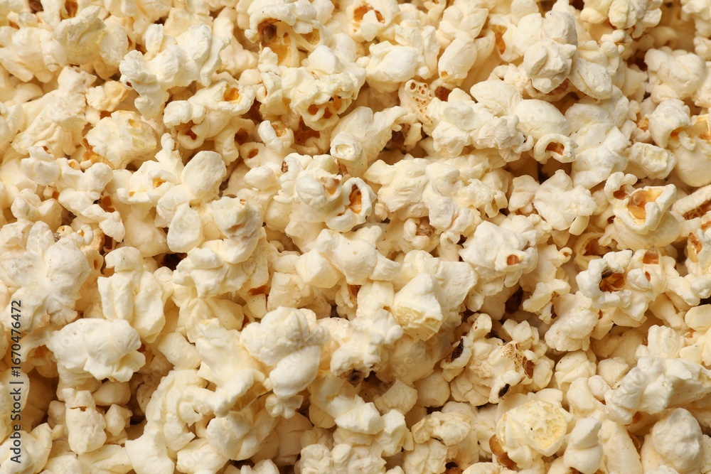 Fresh tasty popcorn as background, closeup view Fresh tasty popcorn as background, closeup view