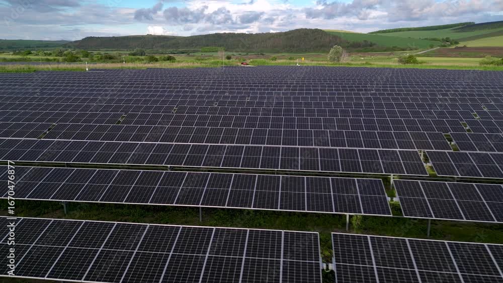 Aerial view of solar panel farm with renewable energy production in countryside. Drone footage showcasing sustainable electricity, photovoltaic technology, and green power.
Aerial view of solar panel farm with renewable energy production in countryside. Drone footage showcasing sustainable electricity, photovoltaic technology, and green power.