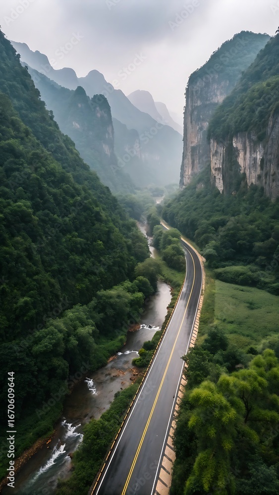 Fototapeta premium Scenic mountain road winding through lush green valley atmospheric high resolution photo
