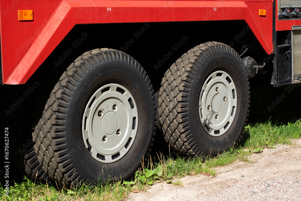 Obraz premium A Detailed Closeup View of Truck Tires Mounted on a Red Vehicle