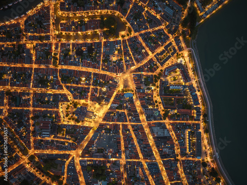 Drone aerial night view of illuminated city streets in Hoorn