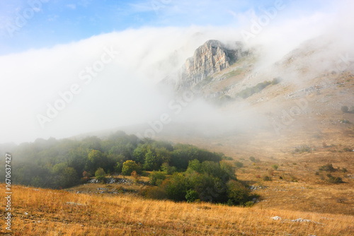 Mysterious rocky cliffs shrouded in clouds or fog. The Chatyr-Dag mountain range in Crimea.