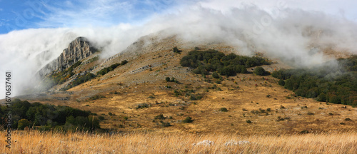 Mysterious rocky cliffs shrouded in clouds or fog. The Chatyr-Dag mountain range in Crimea.