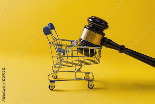 Gavel in Shopping Cart on Yellow Background