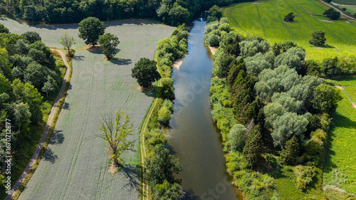 High angle view of the English countryside with a river, forest, and fields