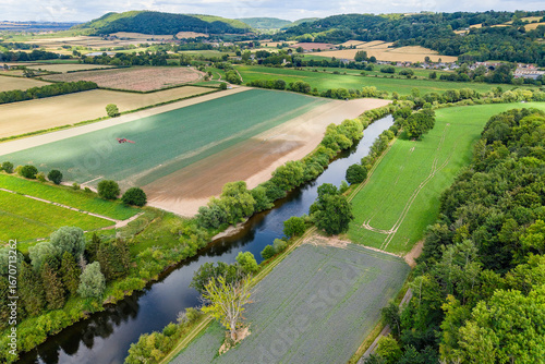 Aerial drone view of the River Wye and patchwork farmland in the Wye Valley, UK