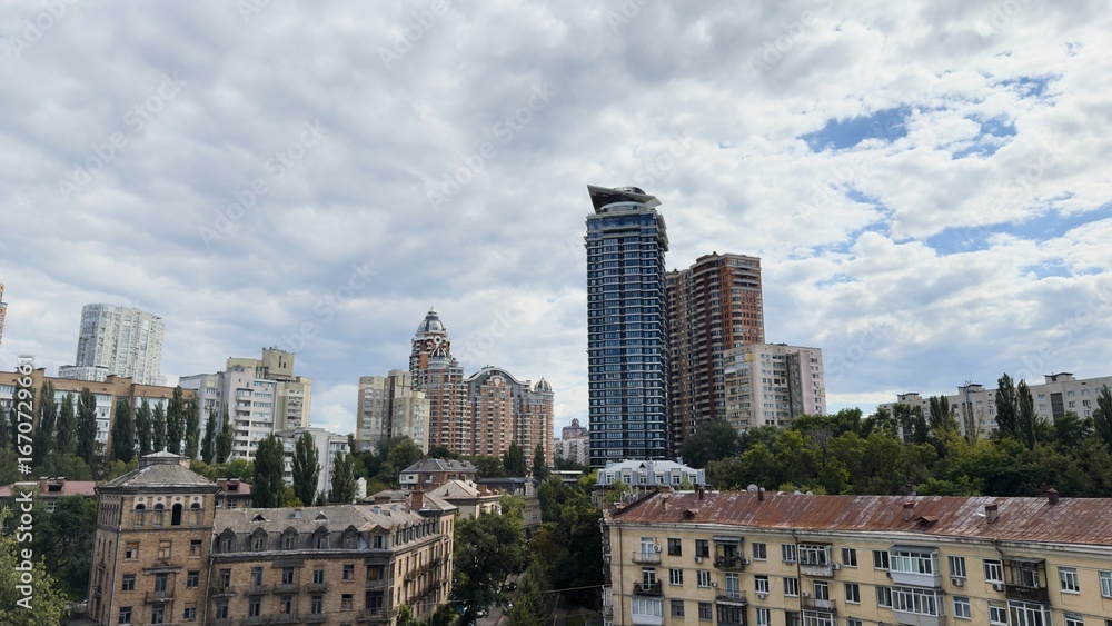 Fototapeta premium Architectural contrast in Kyiv — modern skyscrapers next to old historical buildings