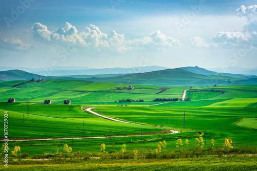 Фотография Puglia countryside landscape, view of rolling hills and a road near Poggiorsini,