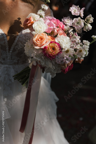 detail of bride holding a modern wedding bouquet of roses