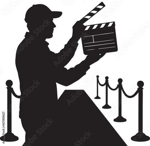 Silhouette of a person wearing a baseball cap holding a clapperboard on a red carpet with stanchions