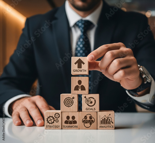 Businessman stacking blocks to build a business growth strategy. Concept of planning, teamwork, goals, and analytics as a foundation for corporate success.

