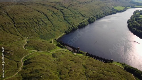 sweeping airborne vista of freshwater lake and retaining structure in southern region