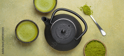 Matcha tea in cups, black iron teapot and matcha powder on a green background, a relaxing and inviting atmosphere for a traditional japanese tea ceremony