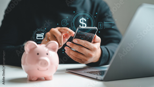 Online banking and savings concept with mobile phone piggy bank and laptop for financial growth