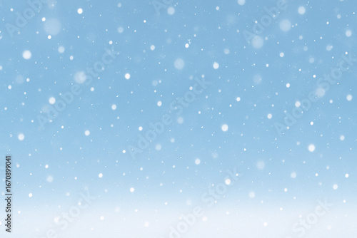 A soft blue background featuring delicate white snowflakes falling, creating a peaceful winter scene. Perfect for seasonal themes, holiday cards, and festive designs.