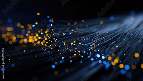 Abstract network of fiber optic cables.  Golden and blue lights disperse along dark lines