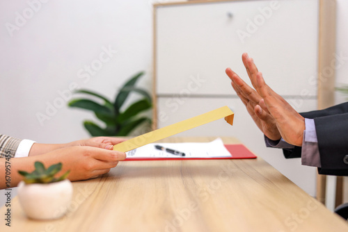 Close Up Of Bribe Rejection Envelope is Offered But Hand Signals 