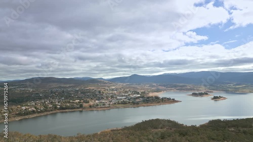 High looking over the town of Jindabyne in the snowy region of Australia. With the lake in the foreground and snow capped peaks in the distance.