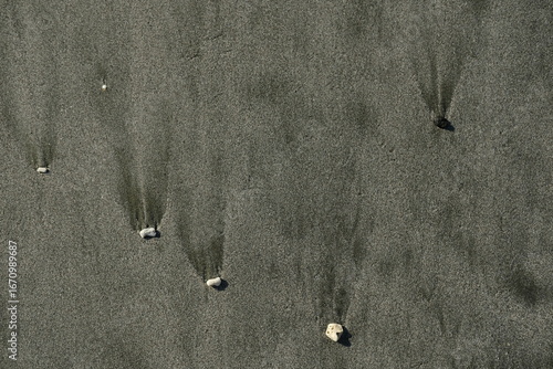 Natural grey sand background with scattered small stones