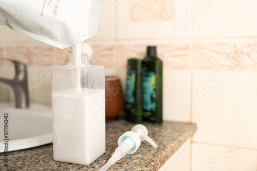 Refilling Body Soap from a Pouch. sustainability and eco friendliness in daily life, showing a simple act of reducing plastic waste by using refillable products.