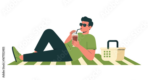 Man Relaxes Outdoors Sipping Iced Drink Beside Picnic Basket on Summer Day