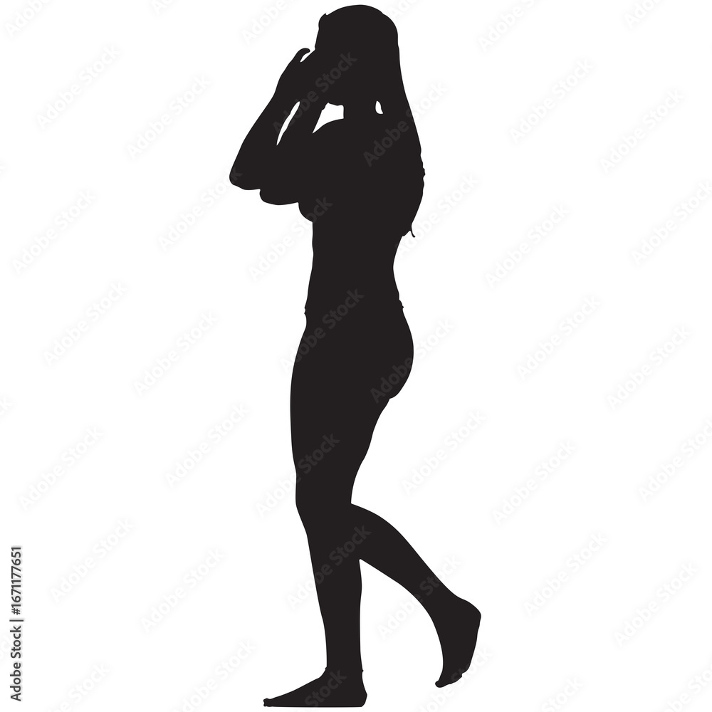 Fototapeta premium A silhouette of a woman walking barefoot in a bikini