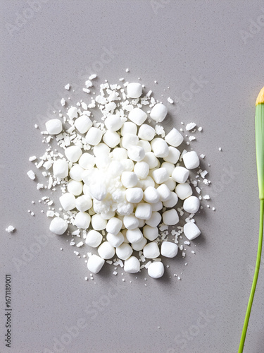 Pellets of ammonium nitrate on grey table. Mineral fertilizer