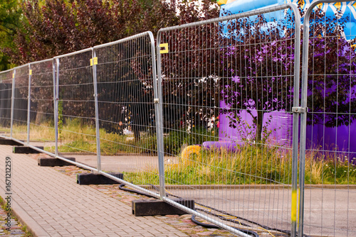 Temporary metal fence on a sidewalk