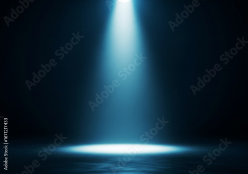 Bright blue spotlight illuminating a dark stage with reflective surface