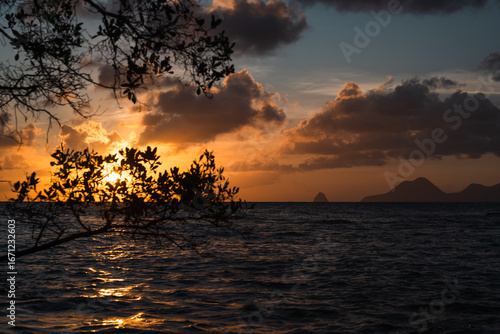 Breathtaking Sunset Over Calm Waters with Silhouetted Mountains in Background