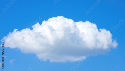 A single fluffy cumulus cloud floats serenely against a vibrant blue sky.