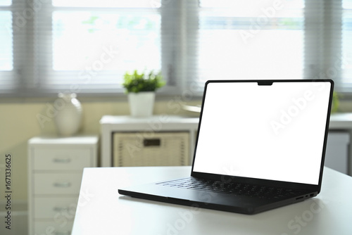 Wallpaper Mural Laptop with blank white screen mockup on desk in bright office interior with natural light Torontodigital.ca
