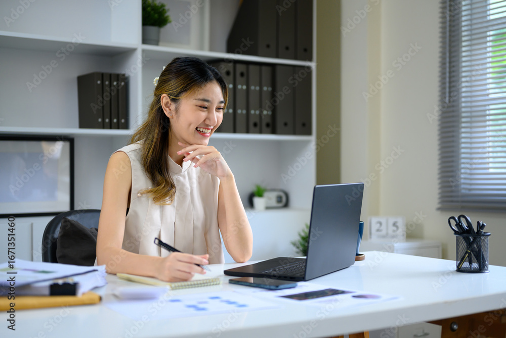 Confident businesswoman working from home office, focused on laptop and planning tasks Confident businesswoman working from home office, focused on laptop and planning tasks