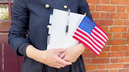 Girl with USA flag and notebook learning English, patriotic education