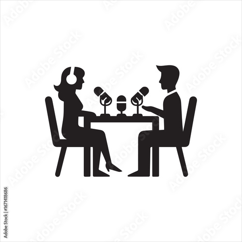 Silhouetted Podcast Interview Two People at Table with Microphones Headphones.