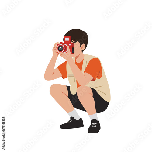 Cartoon illustration of a boy in a beige photographer vest and orange t-shirt squatting while using a red toy camera